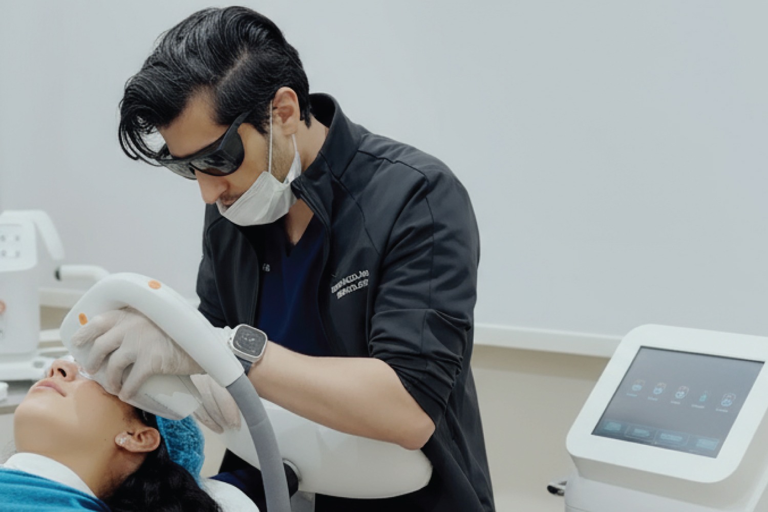 Patient receiving energy-based skin rejuvenation treatment using advanced laser technology at Reveal Clinics Riyadh.