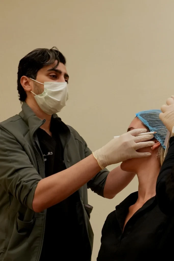 Dr. Haitham Al-Gzlan providing aesthetic dermatology care in Riyadh